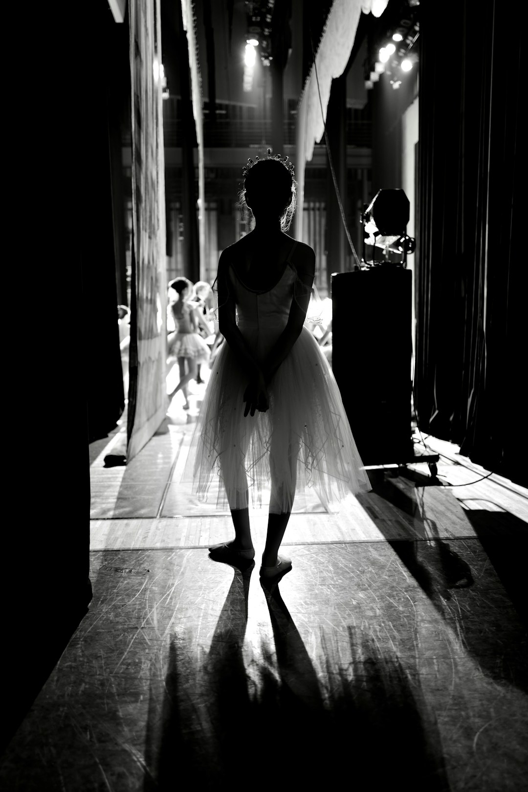 Ballerina in tutu backstage with dramatic lighting. Ballerina in tutu backstage with dramatic lighting.